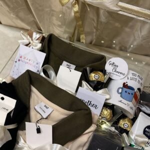 👕 2 stylish T-shirts / polo shirts — olive green & beige 🧴 Horizon Intense perfume 🧴 NIVEA MEN body care product ☕ Cute printed coffee mug 🍫 Ferrero Rocher-style chocolates 💌 Birthday & cute message cards 🎀 White/golden decorative ribbons 💡 Fairy lights 🎁 Premium transparent gift hamper box